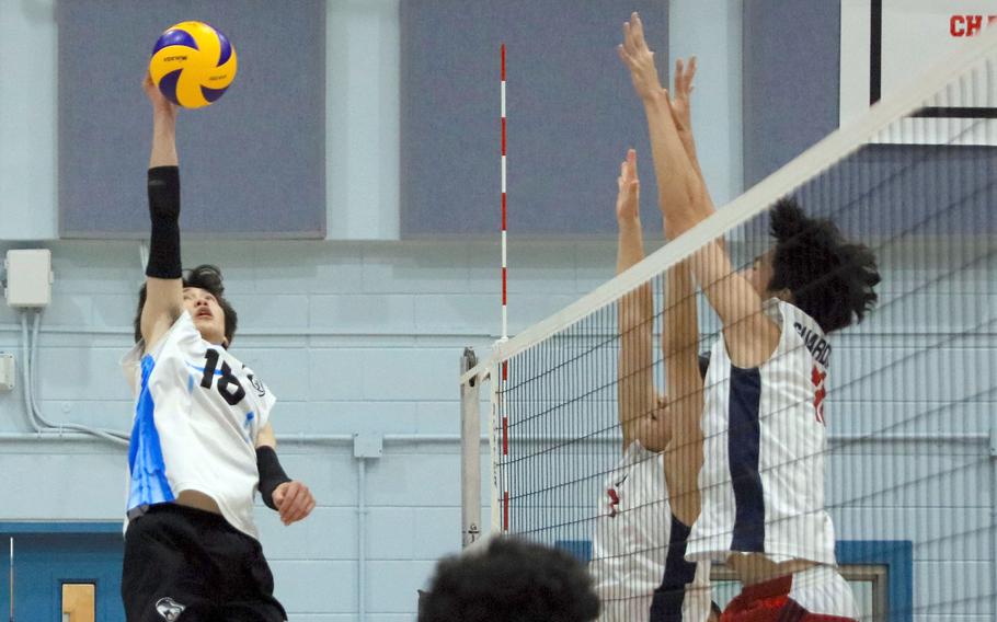 Osan's M.J. Siebert goes up to spike against Yongsan International-Seoul during Saturday's Korea boys volleyball match. The Guardians won in four sets.