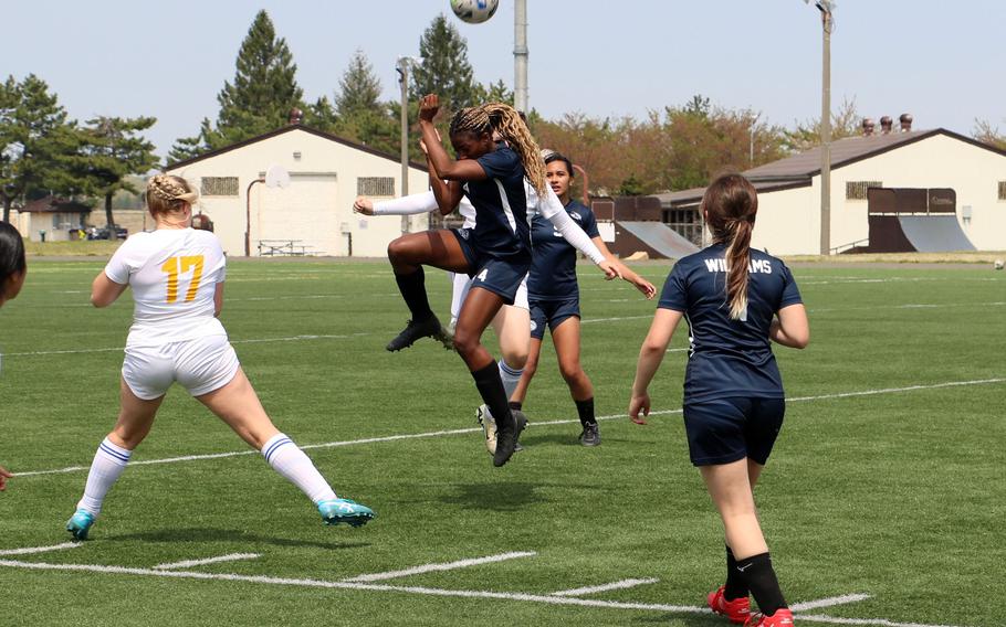 Osan’s Tatiana Lunn goes up to head the ball during Monday’s girls Division II soccer tournament. The Cougars beat host Robert D. Edgren 2-1 and lost 5-2 to Yokota; Lunn scored three goals on Monday.