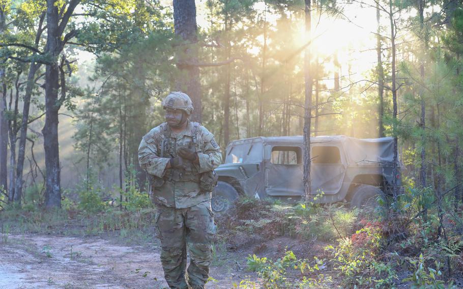 Spc. Ronson Pua of the Hawaii Army National Guard searches July 29, 2023, for tree branches for concealment at Joint Readiness Training Center at Fort Johnson, La.