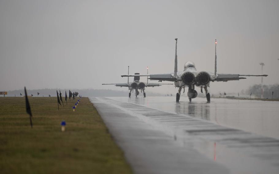 Two F-15C Eagles taxi to the runway in support of NATO operations at Lask Air Base, Poland, Feb. 11, 2022. The aircraft participated in NATOs Enhanced Air Policing mission alongside the Polish and Romanian air forces in Eastern Europe.