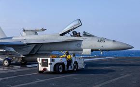 241220-N-KA812-3031 U.S. CENTRAL COMMAND AREA OF RESPONSIBILITY (Dec. 20, 2024) A U.S. Navy Aviation Boatswain's Mate (Aircraft Handling) taxis an F/A-18E Super Hornet, attached to Strike Fighter Squadron (VFA) 136, aboard the Nimitz-class aircraft carrier USS Harry S. Truman (CVN 75) in the U.S. Central Command area of responsibility. (Official U.S. Navy photo)