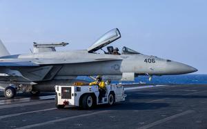 241220-N-KA812-3031 U.S. CENTRAL COMMAND AREA OF RESPONSIBILITY (Dec. 20, 2024) A U.S. Navy Aviation Boatswain's Mate (Aircraft Handling) taxis an F/A-18E Super Hornet, attached to Strike Fighter Squadron (VFA) 136, aboard the Nimitz-class aircraft carrier USS Harry S. Truman (CVN 75) in the U.S. Central Command area of responsibility. (Official U.S. Navy photo)