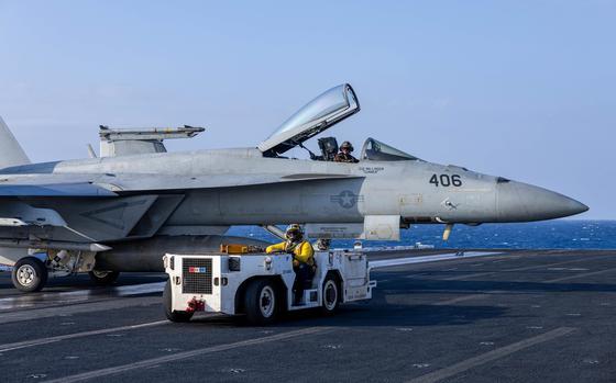 241220-N-KA812-3031 U.S. CENTRAL COMMAND AREA OF RESPONSIBILITY (Dec. 20, 2024) A U.S. Navy Aviation Boatswain's Mate (Aircraft Handling) taxis an F/A-18E Super Hornet, attached to Strike Fighter Squadron (VFA) 136, aboard the Nimitz-class aircraft carrier USS Harry S. Truman (CVN 75) in the U.S. Central Command area of responsibility. (Official U.S. Navy photo)