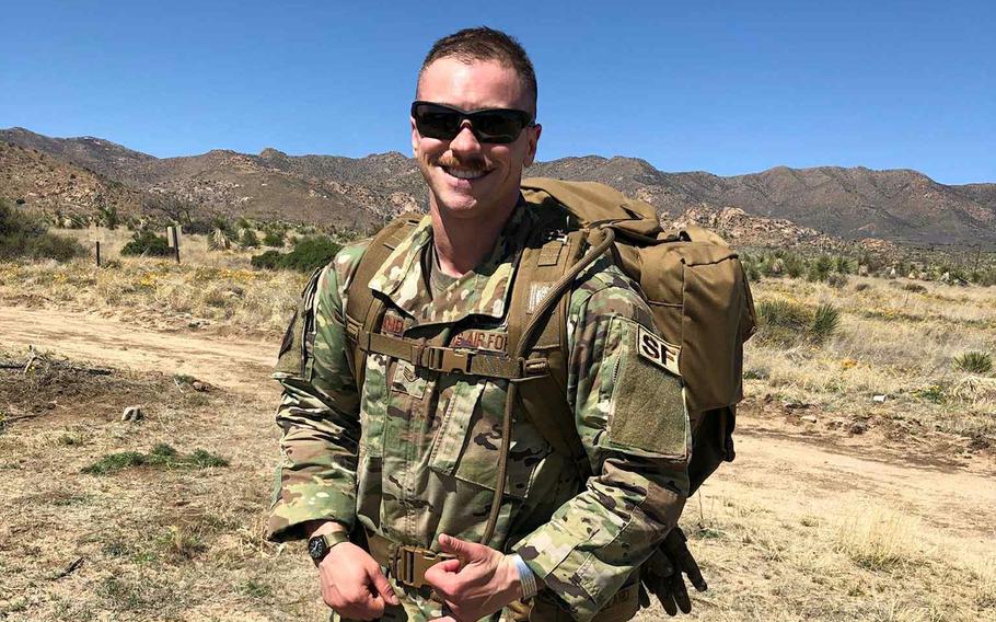 Logan Ireland poses for a photo wearing sunglasses and a uniform.