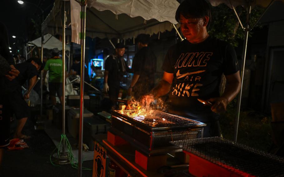 A street vendor grills food.