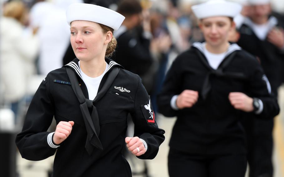 Sailors run aboard a newly commissioned submarine