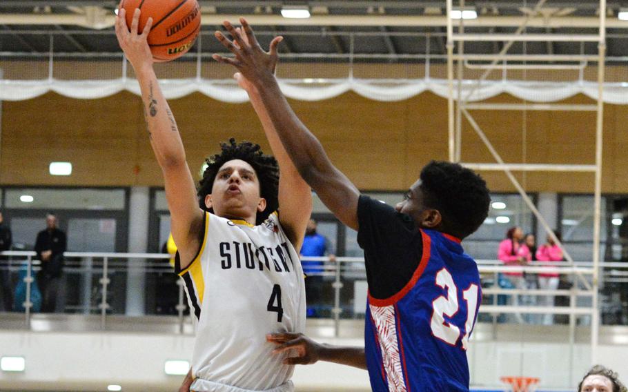 Stuttgart’s Ismael Anglada Paz takes it to the basket against Ramstein’s Aarius Guishard in the boys Division I final at the DODEA-Europe basketball championships in Wiesbaden, Germany, Feb. 17, 2024. Stuttgart took the title with a 47-36 win.