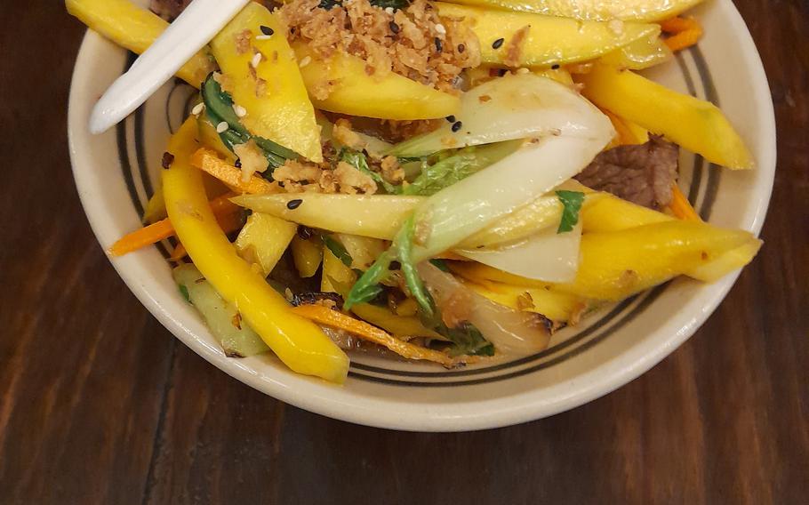 Freshly sliced mango and tangy vinaigrette are the real stars of the Tokygon dish called golden beef.