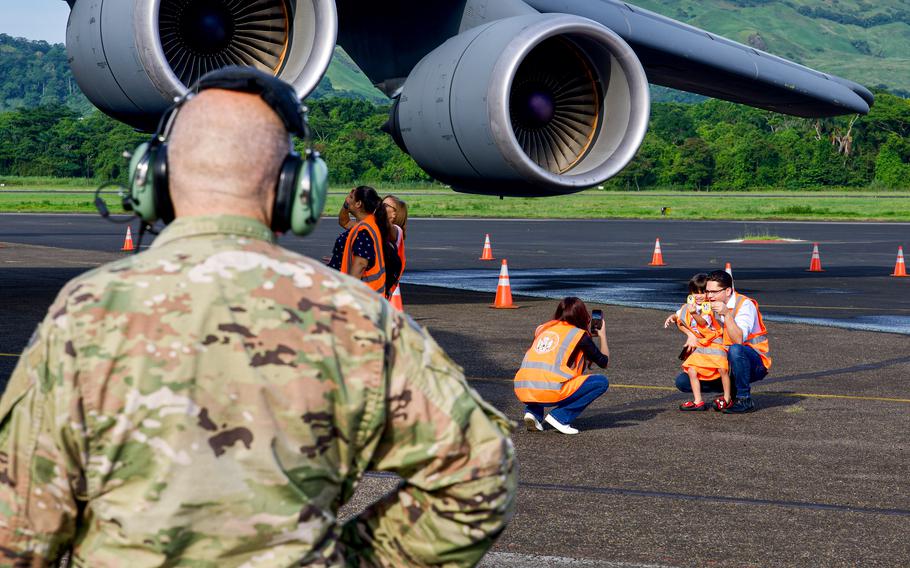 An airman looks at an aircraft.