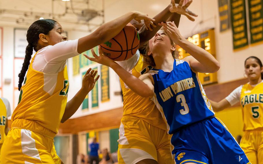 Yokota's Charlotte Rhyne has trouble shooting against Robert D. Edgren's Zalea Washington during Friday's DODEA-Japan girls basketball game. The Eagles edged the Panthers 20-19.