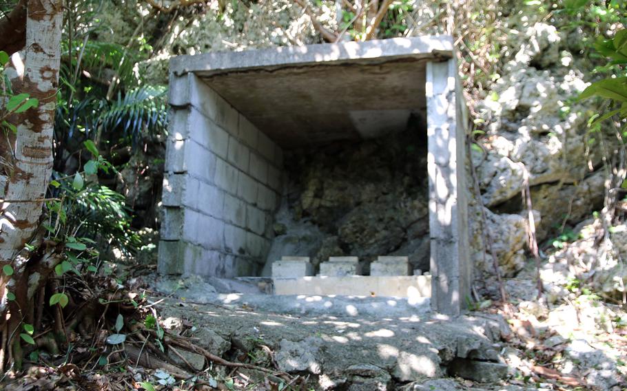 Sailors from the U.S. Navy and Japan Maritime Self-Defense Force worked together Friday, Feb. 17, 2023, to clear a trail through the jungle to this family tomb at White Beach Naval Facility, Okinawa.