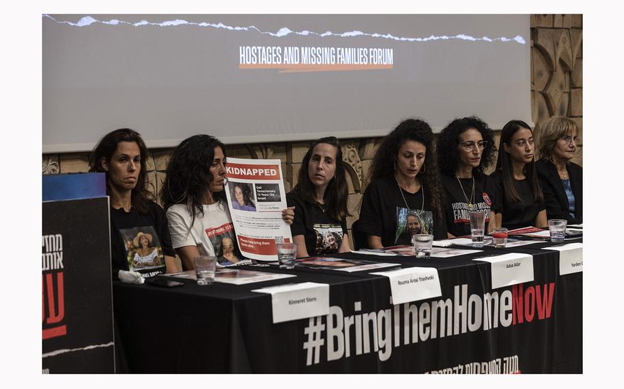 Reuma Tarshansky holds a poster showing Gali, 13, who was kidnapped from her home in Kibbutz Be'eri, as she sits with family members held hostage in Gaza during a conference in Tel Aviv on Nov. 13, 2023.