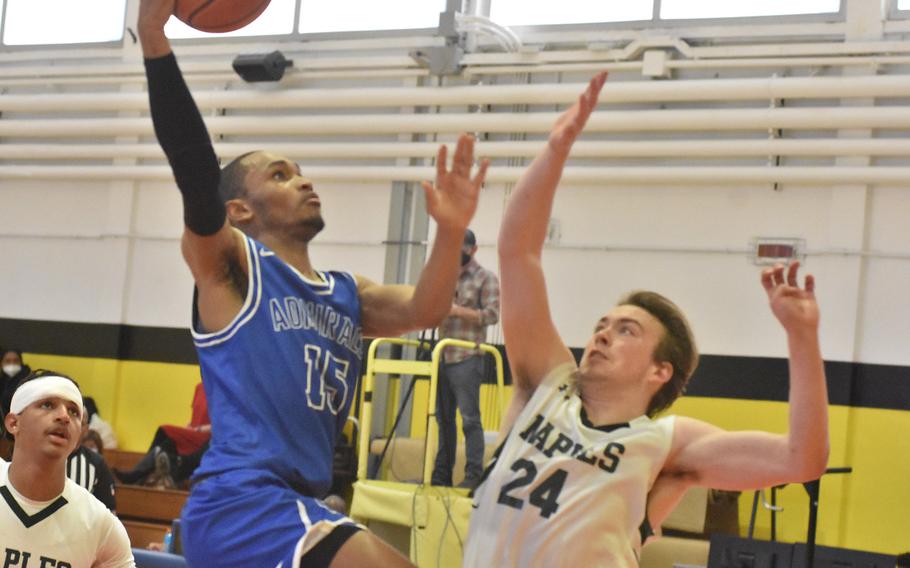 Rota's Emory Butler drives to the basket to score despite the defense of Naples' Corbin Gustafson on Saturday, March 5, 2022, in the championship game of the DODEA-Europe Division II title game.