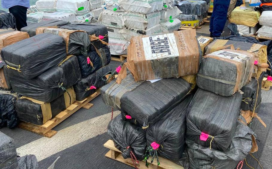 Packages of cocaine and marijuana are stacked on the deck of the U.S. Coast Guard Cutter James Thursday, Feb. 17, 2022.