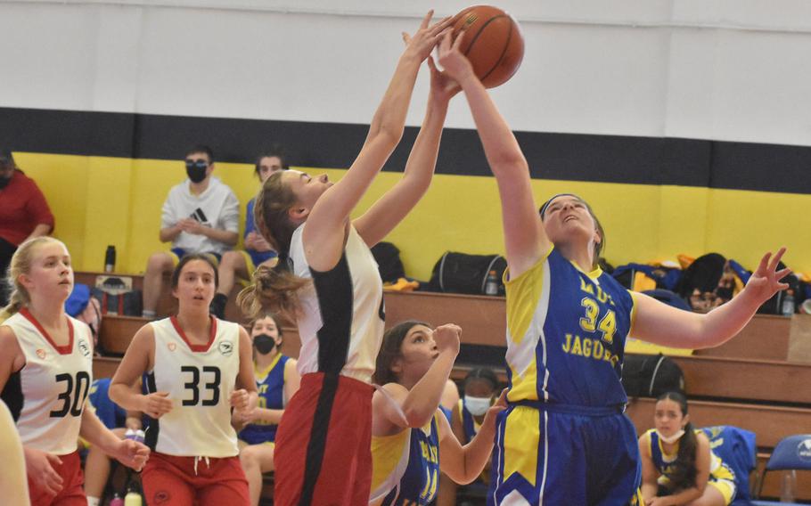 American Overseas School of Rome's Emily Perkins and Sigonella's Laney Reardon battle for a loose ball Saturday, March 5, 2022 in the DODEA-Europe Division II girls championship game. The Falcons won 41-30.