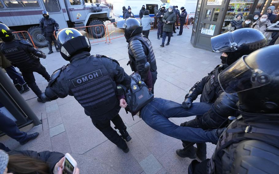 Police detain a demonstrator during an action against Russia’s attack on Ukraine in St. Petersburg, Russia, Sunday, Feb. 27, 2022. Protests against the Russian invasion of Ukraine resumed on Sunday, with people taking to the streets of Moscow and St. Petersburg and other Russian towns for the third straight day despite mass arrests. 