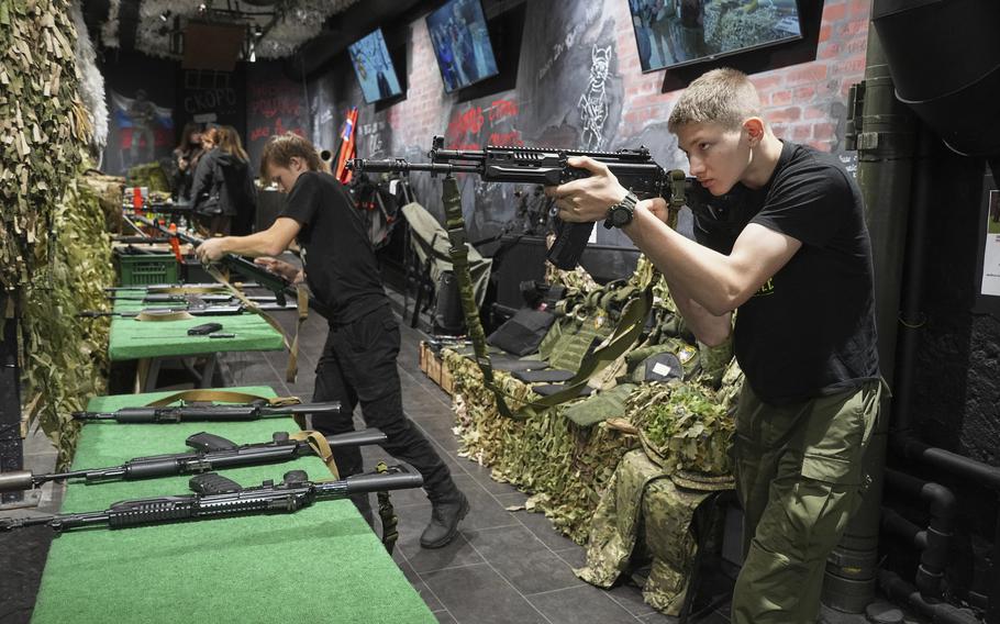 Men aim rifles.