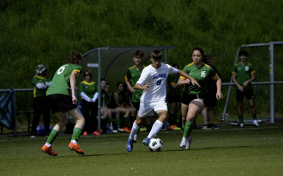 Nathan Hermanson of Sigonella pushes past Alconbury’s Isabella Palomino, right, and Aaron Dudley during the 2024 DODEA European Soccer Division III Championships in Landstuhl, Germany, on May 20, 2024. Sigonella lost to Alconbury 2-0.