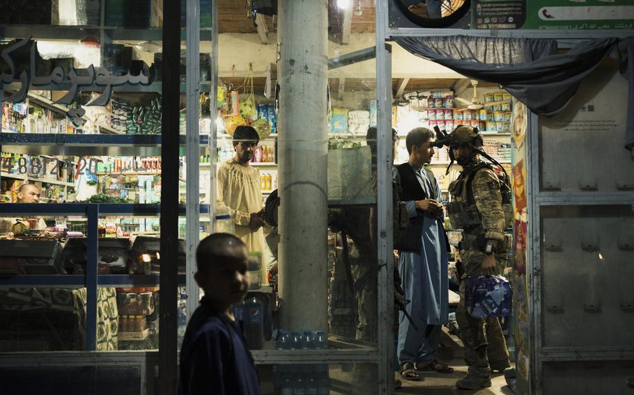 KKA forces stop for water in a local shop just a couple of miles from the front lines before a night mission in Kunduz, Afghanistan, on July 12, 2021.