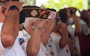 HONOLULU (March 29, 2022) Service members, veterans, distinguished guests, and spectators salute while the national anthem plays during the Vietnam War Veterans Day Ceremony at the National Memorial Cemetery of the Pacific (U.S. Navy photo by Mass Communication Specialist 2nd Class Nick Bauer)