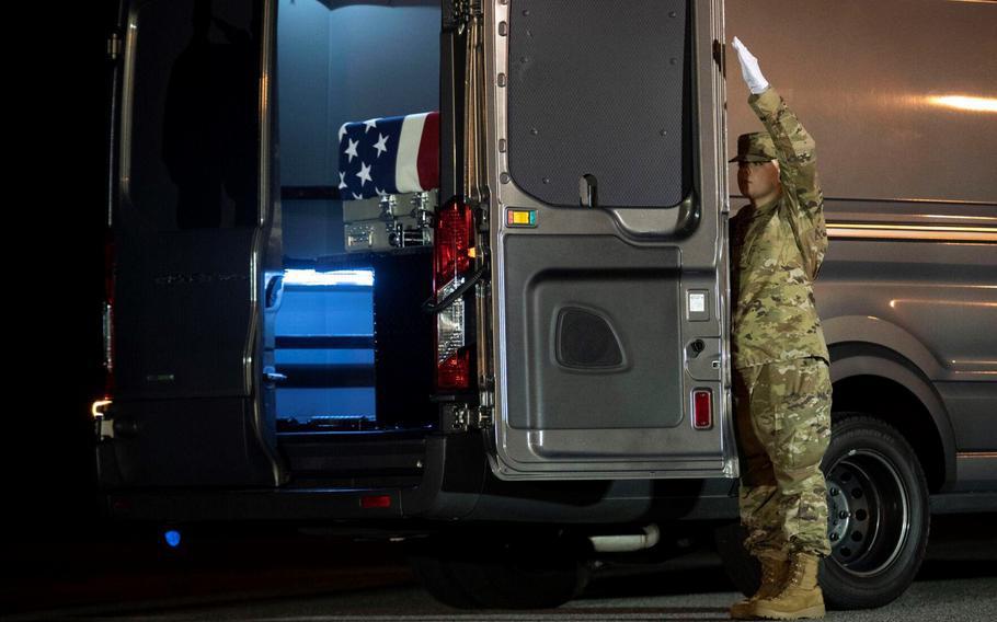 Air Force Staff Sgt. Brenda Barnhart-Frame closes the door of a vehicle containing the remains of Spc. Denisha Montgomery at Dover Air Force Base, Del., on Aug. 15, 2022. Montgomery, of Elizabethtown, Ky., was assigned to the 139th Military Police Company at Fort Stewart, Ga. She died Aug. 9 while deployed to Wiesbaden, Germany.