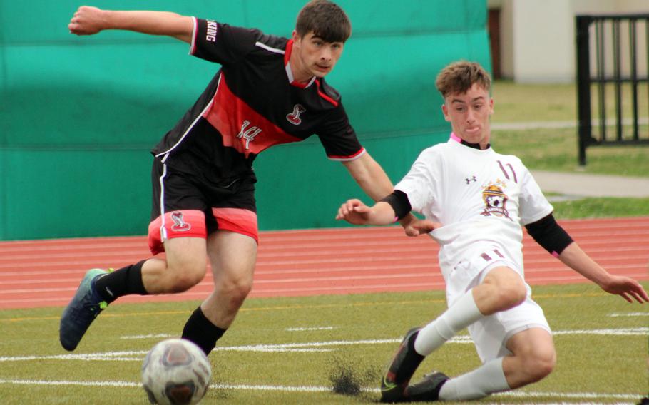 E.J. King's Jacob Ferrer and Matthew C. Perry's James Williams battle for the ball during Friday's DODEA-Japan soccer match. The Samurai won 4-2.