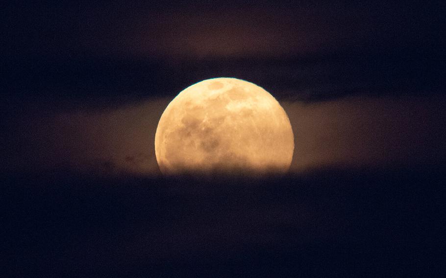 A supermoon rises behind the U.S. Capitol on March 9, 2020, in Washington.