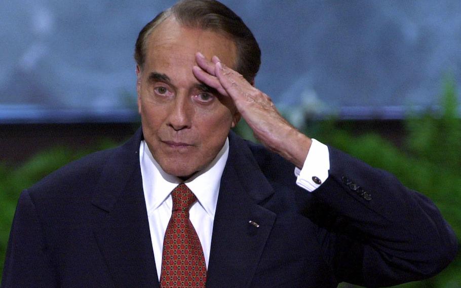 Former senator and former presidential candidate Bob Dole salutes after a speech at the Republican National Convention in the First Union Center in Philadelphia on Aug. 1, 2000. 