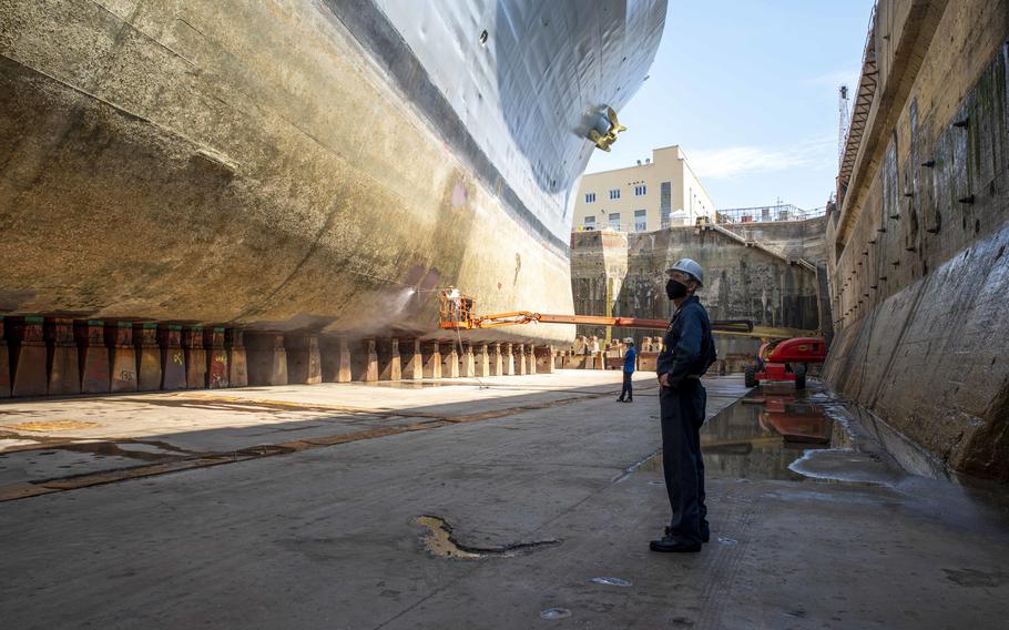 Command Master Chief Petty Officer Jeffrey M. West inspects USS Mount Whitney's hull at a dry dock in Genoa, Italy, July, 28, 2020.  Mount Whitney, the U.S. 6th Fleet flagship, is slated to be decommissioned in 2026, according to Navy budget documents. 