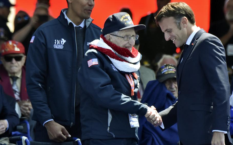 French President Emmanuel Macron shakes hands with World War II veteran Edward Berthold after awarding him the French Legion of Honor during the D-Day 80th anniversary commemoration at Normandy American Cemetery in Colleville-sur-Mer, France, June 6, 2024.
