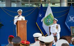 At a change of command ceremony for Allied Joint Forces Command Naples, Adm. Robert P. Burke, standing, hands over authority to Adm. Stuart B. Munsch at JFC Naples, Italy, June 27, 2022. 