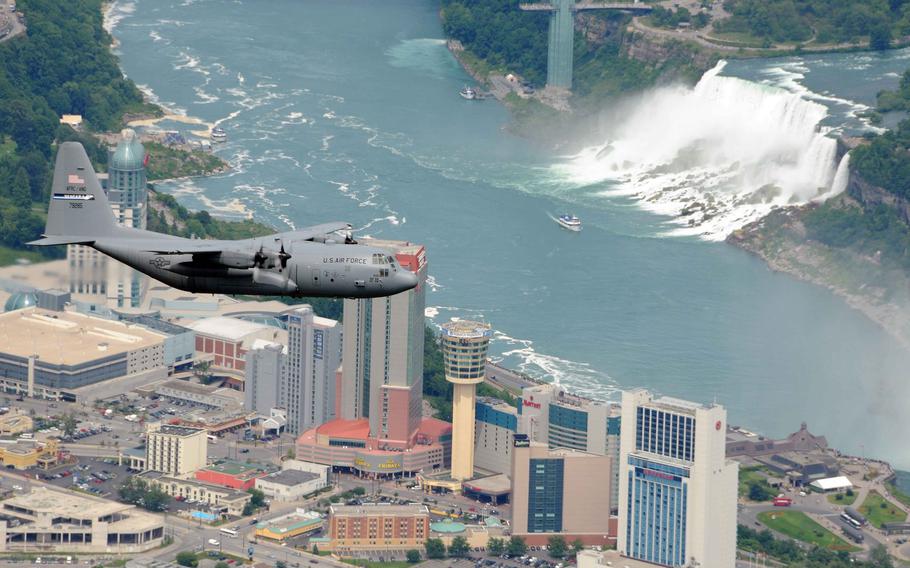 A 914th Airlift Wing C-130 aircraft flies over Niagara Falls, NY.
