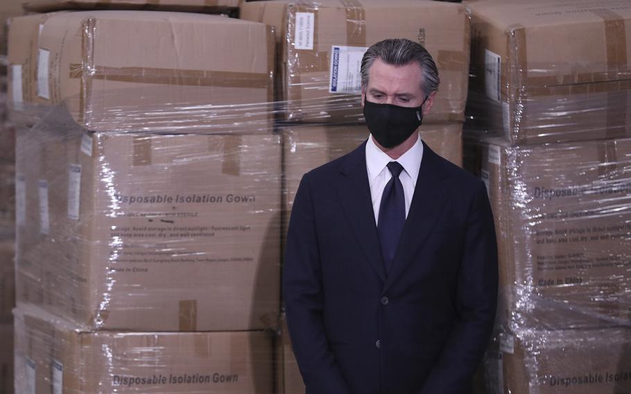 Gov. Gavin Newsom waits to speak at a briefing at a United Parcel Service warehouse in Fontana, Calif., in 2022, to unveil the next phase of California’s pandemic response.