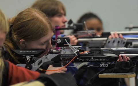 Shooters sight in during their prep time for the kneeling event of the marksmanship competition at the JROTC air rifle range inside Vilseck High School, Vilseck, Germany, on Saturday, Dec. 3, 2022.