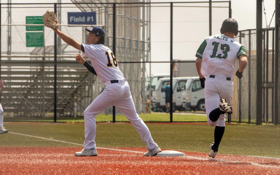 St. Mary's first baseman Ken Brimmer takes the throw well ahead of Kubasaki baserunner Marcus Waltz.
