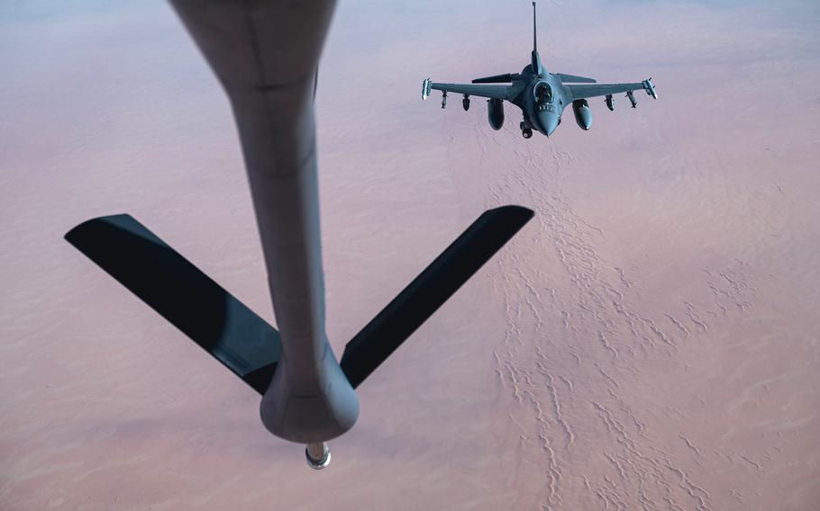 A U.S. Air Force F-16 Fighting Falcon receives fuel from a KC-135 Stratotanker above the U.S. Central Command area of responsibility, Dec. 2, 2021. 