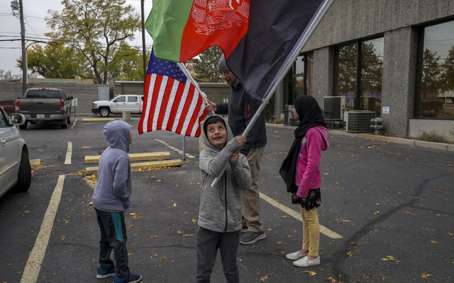 The activists met Afghan families in Billings, Mont., who had been evacuated last year under humanitarian parole, a temporary legal status that expires in 2023. James Powers, rear, and other advocates say the Afghan Adjustment Act will give such evacuees the opportunity to stay permanently and avoid potential deportation back to Afghanistan.