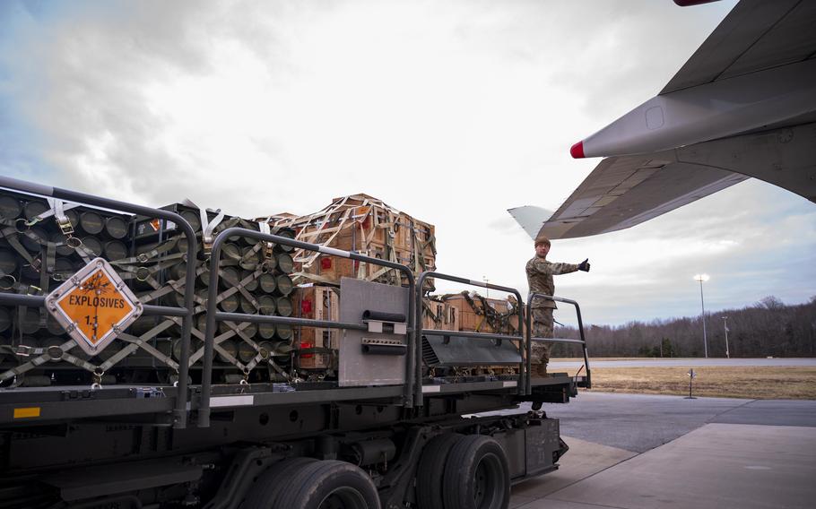 Senior Airman Aaron Howell of the 436th Aerial Port Squadron prepares to load cargo during a security assistance mission at Dover Air Force Base, Del., on Jan. 13, 2023. 