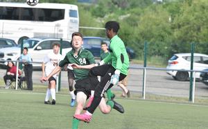 Baumholder goalkeeper Jonathan Kimuli gets to a ball quicker than Alconbury's Gethin Moose during a boys Division III matchup on Monday, May 16 20022 at the DODEA-Europe soccer championships in Reichenbach, Germany.
