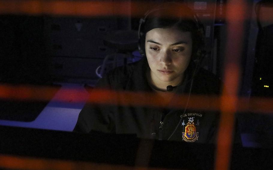 Petty Officer 3rd Class Brianna Vasquez-Ragan monitors surface contacts from the combat information center as the guided-missile destroyer USS Benfold sails through the Taiwan Strait, Wednesday, July 28, 2021. 