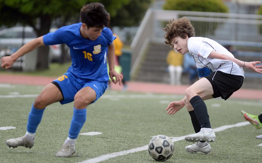 Yokota's Alex Kosinski and Zama's Tyler Deiwert almost lose their purchase as they chase down the ball during Thursday's All-DODEA-Japan soccer tournament. The teams played to a 1-1 draw.