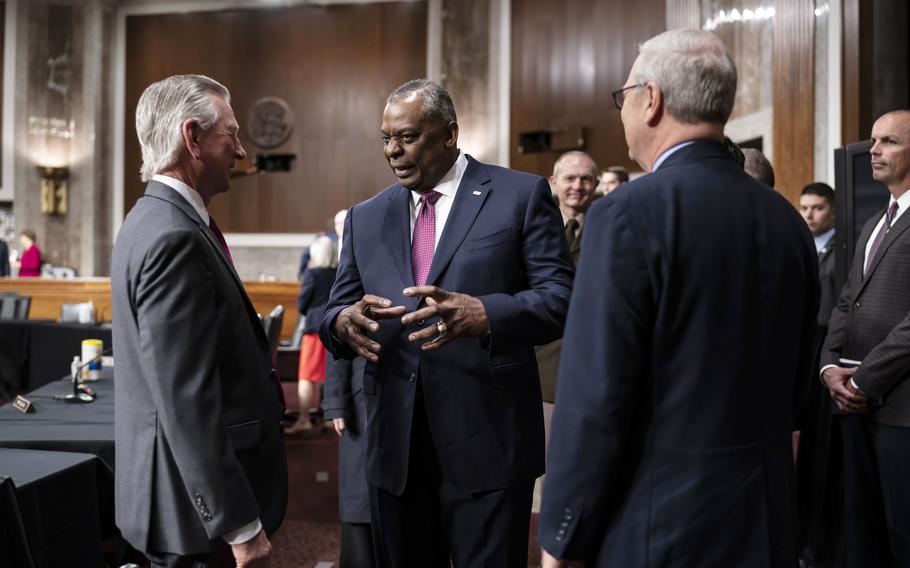 Defense Secretary Lloyd Austin, flanked by Sens. Tommy Tuberville, R-Ala., left, and Kevin Cramer, R-N.D., arrives at the Capitol in Washington on Thursday, April 7, 2022, to go before the Senate Armed Services Committee to discuss the military’s budget for fiscal year 2023.