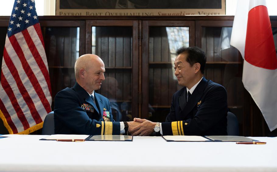 U.S. Coast Guard Rear Adm. Bill Kelly, superintendent of the U.S. Coast Guard Academy, and Japan Rear Adm. Mitsuru Eguchi, supertintendent of the Japan Coast Guard Academy, meet in New London, Conn., April 21, 2023. 