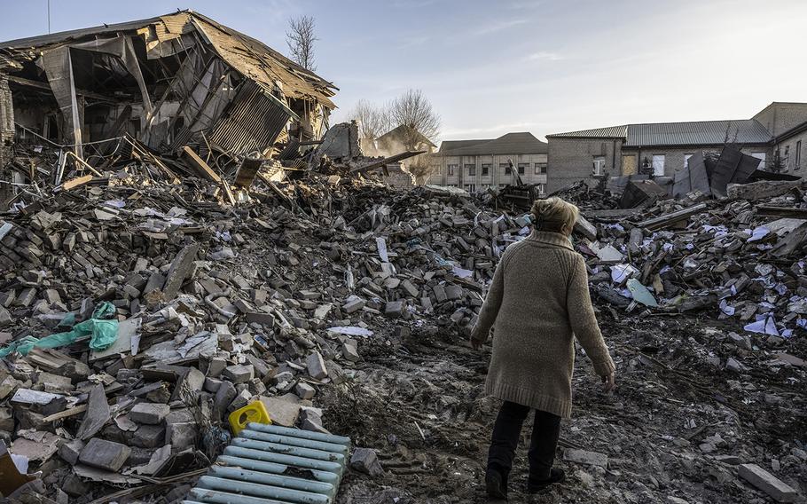 A hospital worker walks amid the rubble at a hospital in Vilnyansk, Ukraine, on Nov. 23, 2022, after an early-morning airstrike. 