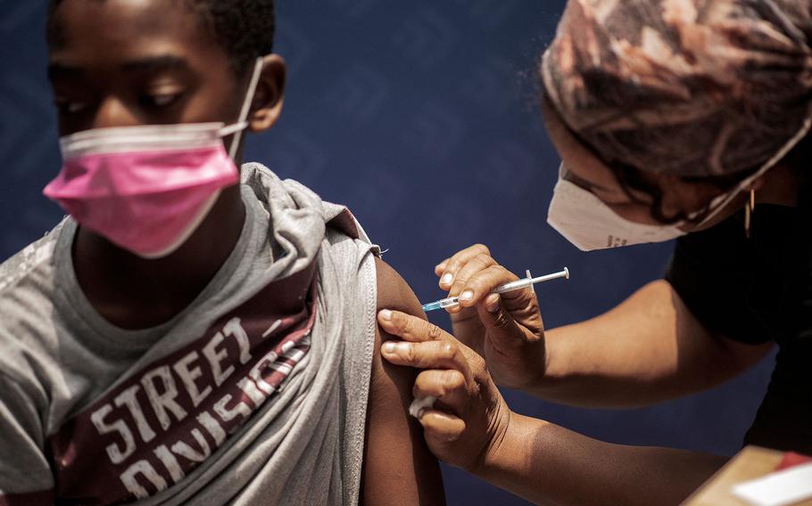 A boy receives a dose of the Pfizer/BioNTech vaccine against COVID-19 at Discovery vaccination site in Sandton, Johannesburg, on Dec. 15, 2021.