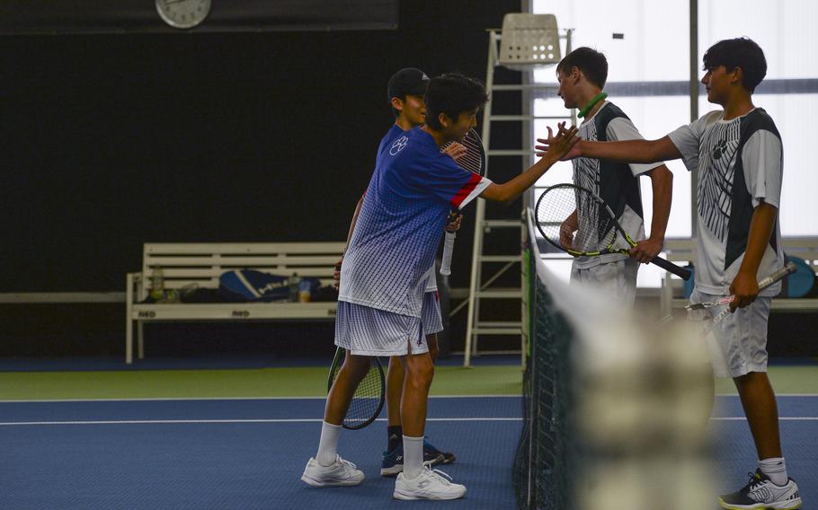 After a fierce contest on the courts, Ramstein’s Kim brothers, Eric and Sean, share a moment of sportsmanship with a high five after their win against Naples’ dynamic duo, Kai Barania and Tavi Shah at the DODEA European tennis championships at T2 Sports Health Club in Wiesbaden, Germany, on Oct. 21, 2023. The Kims bested all teams for the overall first place in the boys double.