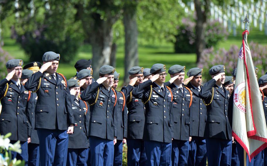 Cadets of the Stuttgart High School Army Junior Reserve Officers’ Training Corps program salute during the playing of the American and French national anthems at the Memorial Day ceremony at Lorraine American Cemetery in St. Avold, France, May 28, 2023.