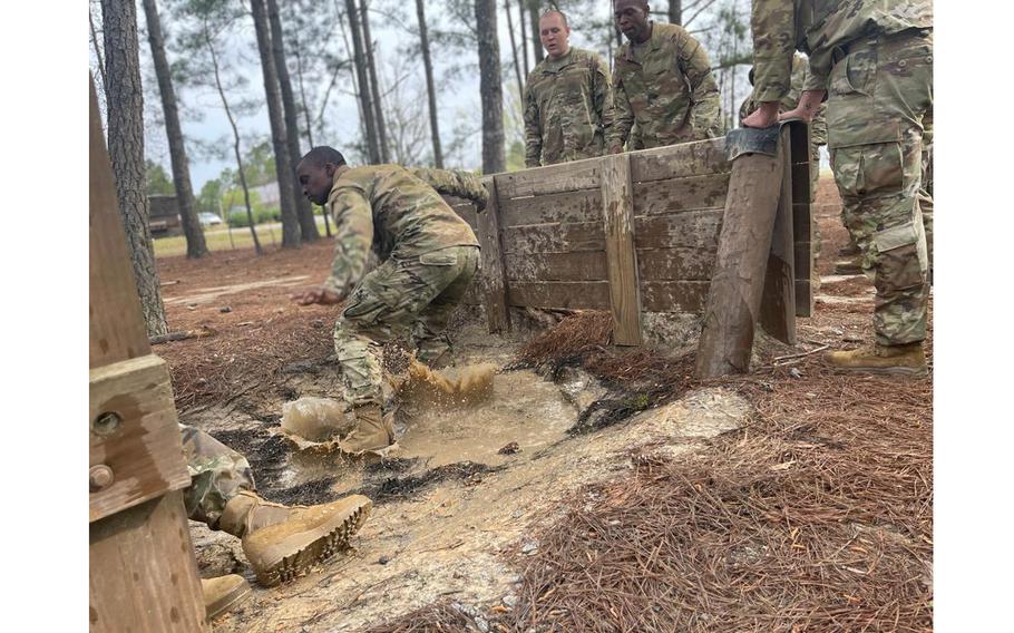 Trainees with Echo Company, 2nd Battalion, 39th Infantry Regiment at Fort Jackson, S.C., compete on an obstacle course in March 2022. 