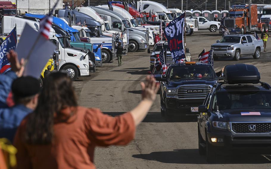 Supporters cheer and wave as the "People's Convoy" departs Hagerstown Speedway for the Capital Beltway on March 11, 2022, in Hagerstown, Md. 