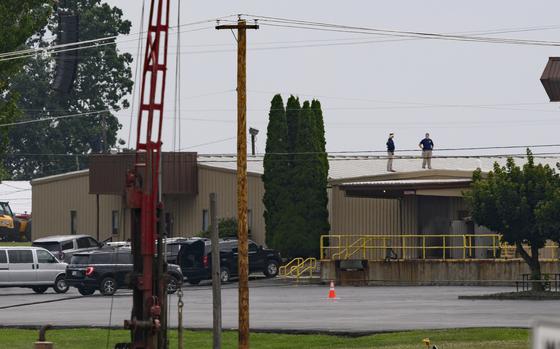 Two FBI investigators scan the roof of AGR International Inc, the building adjacent to the Butler Fairgrounds, from which alleged shooter Matthew Thomas Crooks fired at former President Donald J. Trump, in the aftermath of the attempted assassination at a campaign rally, on Sunday, July 14, 2024, in Butler, Pa. 